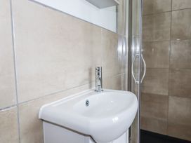 A bathroom with a sink and a shower at The Three Tees in Newquay