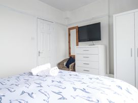 A bedroom with a bed and a television at The Three Tees in Newquay