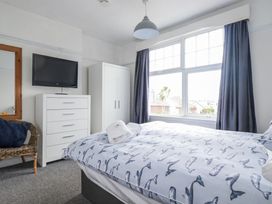 A bedroom with a bed and television at The Three Tees in Newquay