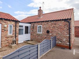 A house with a brick exterior and lion statue at Southview Bungalow in Barmston