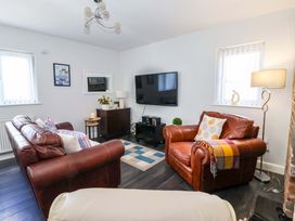 A living room with a sofa and armchair at Southview Bungalow in Barmston
