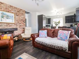 A living room with a sofa and chairs at Southview Bungalow in Barmston