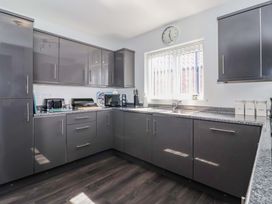 A kitchen with grey cabinets and countertop at Southview Bungalow in Barmston