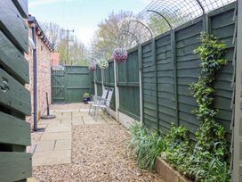 A garden with gravel pathway and chairs at Southview Bungalow in Barmston