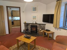 A living room with a fireplace and television at The Roundhouse in Warbstow