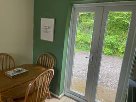 A dining room with a table and chairs at Eirlys Caeathro near Caernarfon