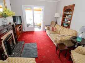 A living room with a television and fireplace at Churchfield House Moygownagh near Crossmolina County Mayo