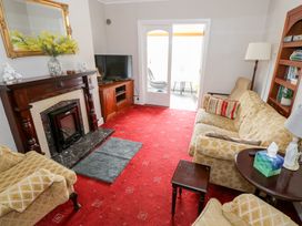 A living room with a sofa and armchair at Churchfield House in Moygownagh near Crossmolina, County Mayo