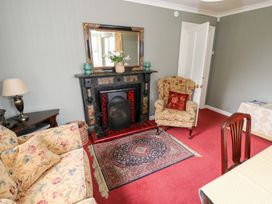 A living room with a fireplace and sofa at Churchfield House Moygownagh near Crossmolina, County Mayo