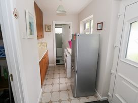 A kitchen with a refrigerator and washing machine at Churchfield House, Moygownagh near Crossmolina, County Mayo