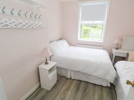 A bedroom with a double bed and a bedside table at Churchfield House Moygownagh near Crossmolina, County Mayo