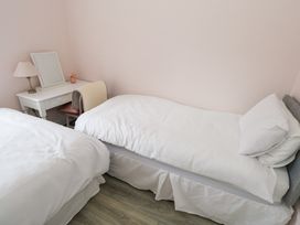 A bedroom with two beds and a desk at Churchfield House, Moygownagh near Crossmolina, County Mayo