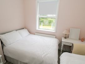 A bedroom with a bed and nightstand at Churchfield House in Moygownagh near Crossmolina, County Mayo