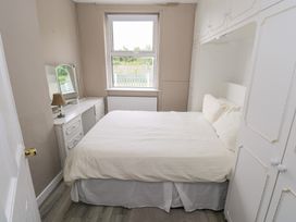 A bedroom with a bed and dresser at Churchfield House Moygownagh near Crossmolina, County Mayo