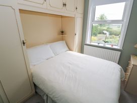A bedroom with a bed and window at Churchfield House in Moygownagh near Crossmolina, County Mayo
