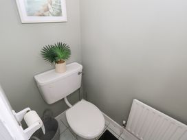 A bathroom with a toilet and plant at Churchfield House in Moygownagh near Crossmolina, County Mayo