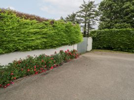 An outdoor area with a hedge and flower bed at Churchfield House, Moygownagh near Crossmolina, County Mayo