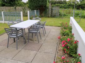 An outdoor area with a table and chairs at Churchfield House in Moygownagh near Crossmolina, County Mayo