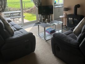 A living room with sofas and a coffee table at Watergate Bay in Liskeard