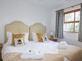 A bedroom with two beds and a nightstand at Tresawle in Crantock