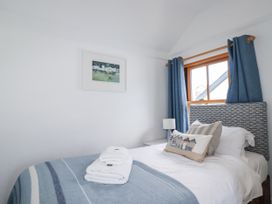 A bedroom with a bed and decorative pillows at Tresawle in Crantock