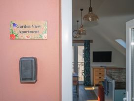 An entryway with a sign and view of the living area at Garden View Apartment in Kingsbridge