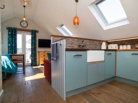 A kitchen with sink and cabinets at Garden View Apartment in Kingsbridge
