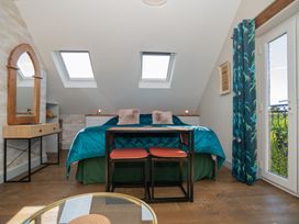 A bedroom with a bed and a table at Garden View Apartment in Kingsbridge