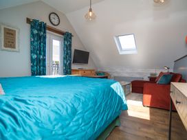 A bedroom with a bed and television at Garden View Apartment in Kingsbridge