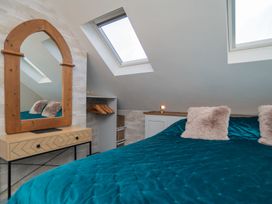 A bedroom with a mirror and bed at Garden View Apartment in Kingsbridge