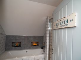 A bathroom with bathtub and shower at Garden View Apartment in Kingsbridge