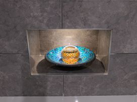 A decorative bowl on a shelf in a bathroom at Garden View Apartment in Kingsbridge