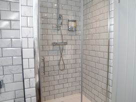 A shower area with tiles and a showerhead at Garden View Apartment in Kingsbridge