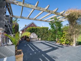 A garden with a pergola and decorative plants at Garden View Apartment in Kingsbridge