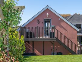 A house with a deck and stairs at Garden View Apartment in Kingsbridge