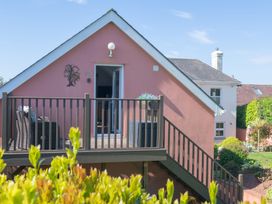 A house with a deck and outdoor furniture at Garden View Apartment in Kingsbridge