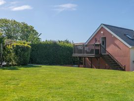 A house with a deck in a garden at Garden View Apartment in Kingsbridge
