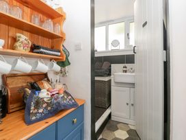 A kitchen with shelves and a sink at Avonmede Tewkesbury