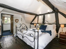 A bedroom with a bed and bedside table at Avonmede Tewkesbury