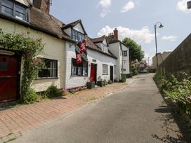 A street view of houses with brick path and plants at Avonmede Tewkesbury