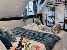 A bedroom with a bed and towels at Avonmede Tewkesbury