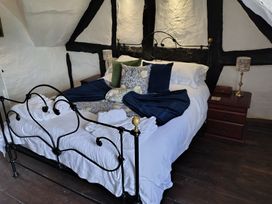 A bedroom with a bed and bedside table at Avonmede Tewkesbury