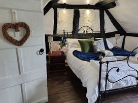 A bedroom with a bed and bedside table at Avonmede in Tewkesbury