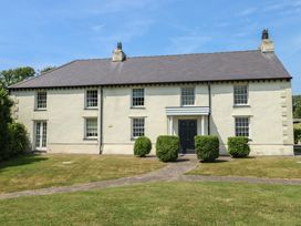 A house with greenery and a pathway at Clynnog House Dwyran near Newborough