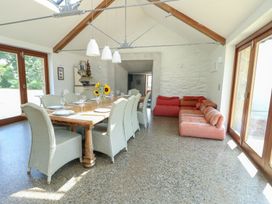A dining room with a table and chairs at Clynnog House Dwyran near Newborough