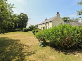 A house with a garden and trees at Clynnog House Dwyran near Newborough