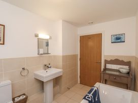 A bathroom with a sink and a bathtub at Sail Away, 17 Union Mill, Whitby