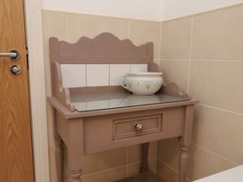 A table with a bowl on top in a bathroom at Sail Away, 17 Union Mill, Whitby