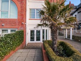 An outdoor area with a palm tree and bushes at Sail Away, 17 Union Mill in Whitby