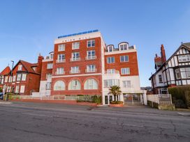 A building with windows and a fence at Sail Away, 17 Union Mill in Whitby